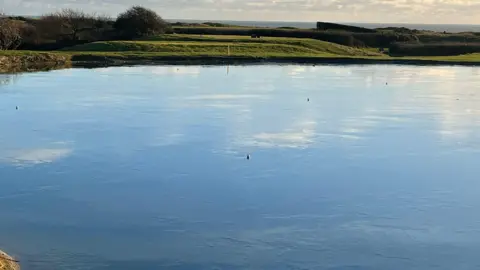 Stewart Owen Golf balls can be seen on a frozen moat