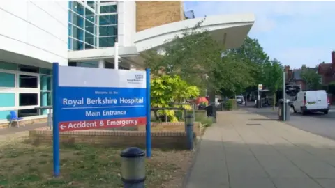 Royal Berkshire Hospital outside of the building with hospital blue, white and red sign.