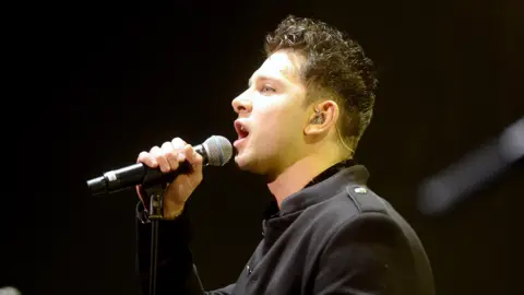 Ross Davidson performing on stage in 2018 