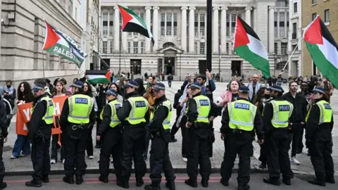 Getty Images London police prevent Youth Demand protesters stepping into the road after they gathered at the Jubilee Gardens