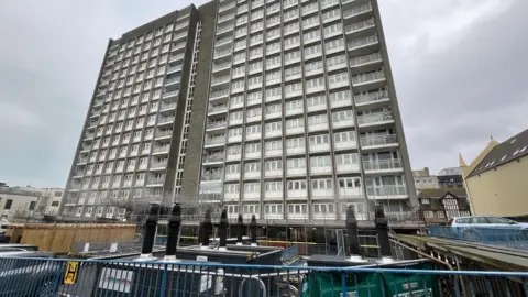 St James' House block which is 15 storeys tall and pictured in the foreground are the temporary boilers which have chimneys blowing out steam 