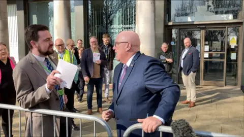 Reform UK's Mick Barton and Sam Smith from the Conservatives argue in front of Nottinghamshire County Council