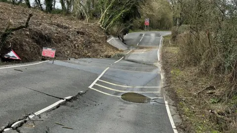 A wonky road with surface splits and raised parts