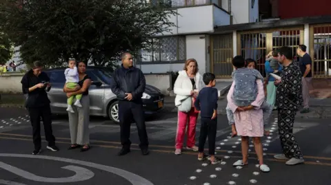 People gathered outside a building in Bogota