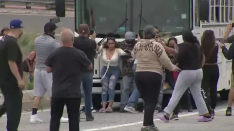 People try to block law enforcement vehicle in a Los Angeles street