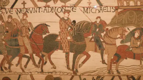 A detail from the Bayeux Tapestry showing several figures on horeeback