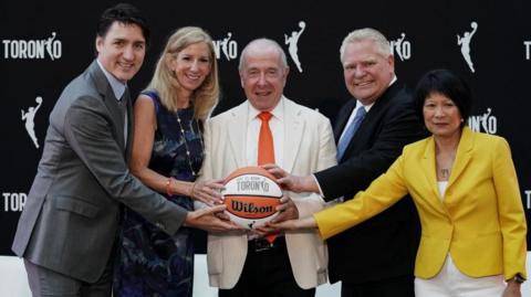 Canada’s Prime Minister Justin Trudeau, WNBA Commissioner Cathy Engelbert, Larry Tanenbaum, Chairman and CEO of Kilmer Group, the Premier of Ontario Doug Ford, and Mayor of Toronto Olivia Chow pose for a photo