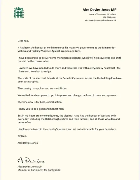 Crown Copyright Alex Davies-Jones' resignation letter reads: Dear Keir,
It has been the honour of my life to serve his majesty's government as the Minister for Victims and Tackling Violence Against Women and Girls.
I have been proud to deliver some monumental changes which will help save lives and shift the dial on the conversation.
However, we have needed to do more and therefore it is with a very, heavy heart that I feel I have no choice but to resign.
The scale of the electoral defeats at the Senedd Cymru and across the United Kingdom have been catastrophic.
The country has spoken and we must listen.
We waited fourteen years to get into power and change the lives of those we represent.
The time now is for bold, radical action.
"I know you to be a good and honest man.
But in my heart are my constituents, the victims I have had the honour of working with every day, including the Hillsborough victims and their families, and all those who demand better of us.
I implore you to act in the country's interest and set out a timetable for your departure.
Ymlaen,
Alex Davies-Jones