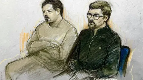PA Media A court sketch of Gary O'Grady, who is wearing a tan tracksuit and has short brown hair and a goatee beard, sitting next to Joey Barton, who is wearing a dark fleece and also has a goatee beard, and is wearing glasses.