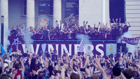 ston Villa players celebrate during the Europa League winners parade in Birmingham