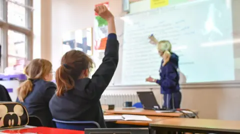 File photo dated of a teacher and students in a classroom