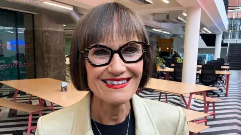 Dark-haired woman in glasses.