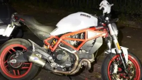 Met Police The getaway bike is believed by police to be a Ducati Monster with a white body, red chassis and red wheels