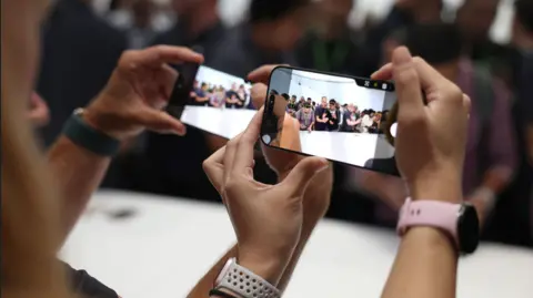 Getty Images People effort   retired  the caller   Apple iPhone 16 which has a fastener  for the camera