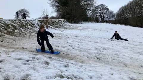 Mark Ansell/BBC Alex, 12, snowboarding in Bingham Park in Sheffield