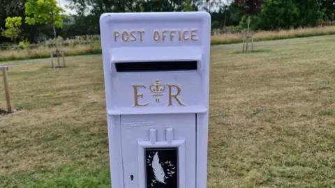 Bradford Council A white post box with the traditional markings including the Royal Cipher of Elizabeth II