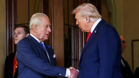 Kevin Lamarque / Reuters King Charles and President Trump shaking hands while the president was on a trip to the UK in September.