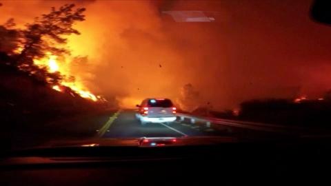 Vehicle drives through wildfire