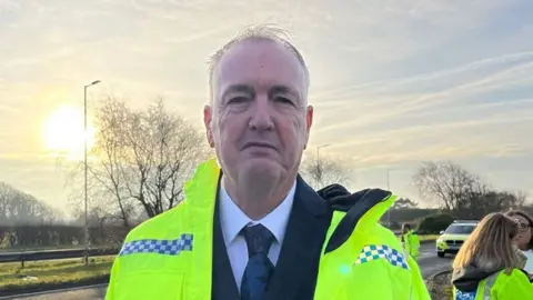 Lancashire police and crime commissioner Clive Grunshaw wearing a hi-vis jacket at the A59 at Robin Island where roadside checks for drink and drug driving are taking place