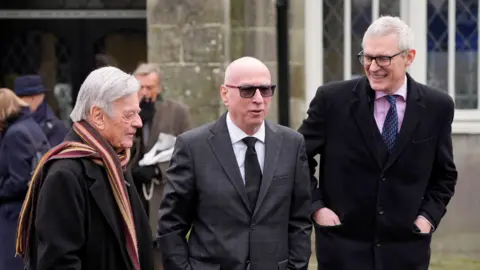 PA Media Tony Blackburn, Ken Bruce and Jeremy Vine following the funeral of DJ Johnnie Walker at St Peter's Church in Shaftesbury.