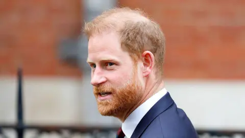 Prince Harry, Duke of Sussex (wearing a Household Division regimental tie and navy suit) departs The Royal Courts of Justice
