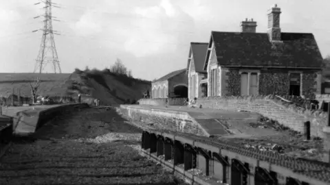 Avon Valley Railway collection A black and white photo of a derelict station building with track ripped up in the foreground