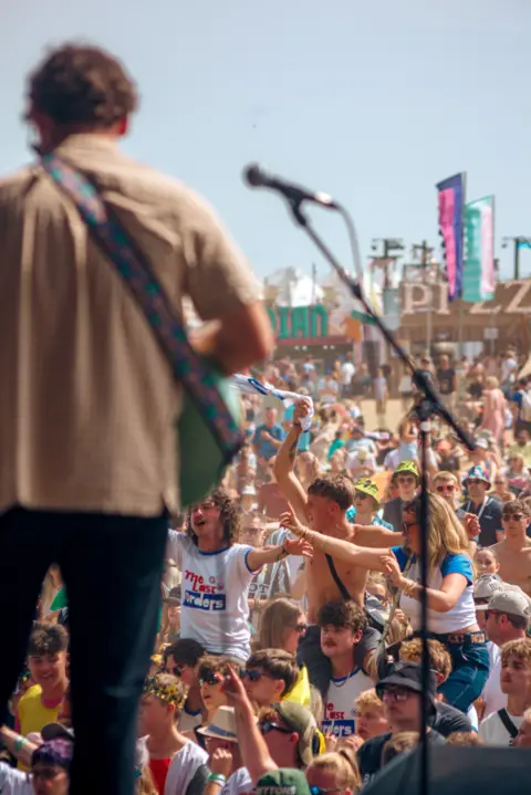Jack Betts A man on stage in front of a crowd 