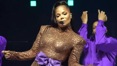 Getty Images Janet Jackson singing on stage