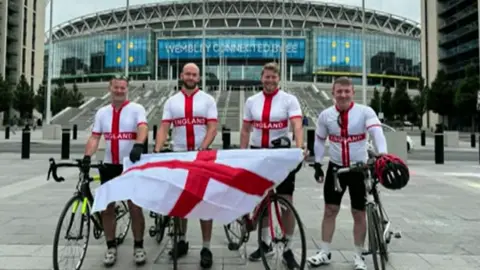 Tony Hunt England football fans with bikes posing in front of Wembley stadium