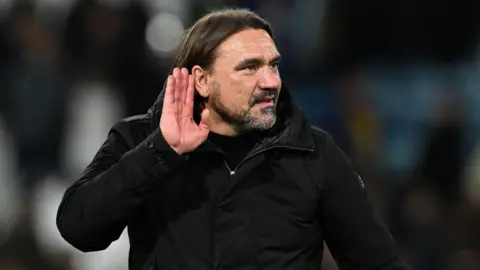 Daniel Farke cups his ears to the crowd