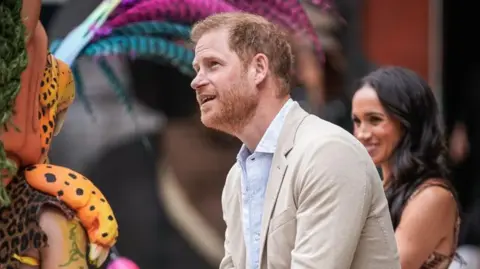 Getty Images Prince Harry and Meghan meeting performers in Colombia