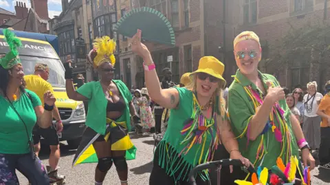 Four people wearing colourful outfits in Leicester