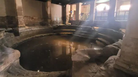 Bath and North East Somerset Council A small round Bath sunked in the ground 