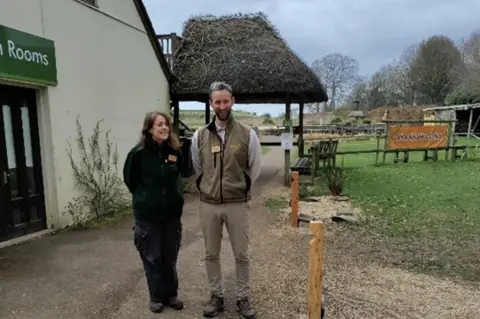 Test Valley Borough Council Staff at the trust on the grounds of the park. An arena fenced off by wooden posts is behind them.