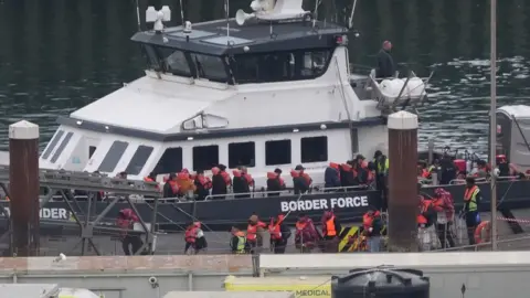 A group of people thought to be migrants are brought in to Dover, Kent, from a Border Force vessel following a small boat incident in the Channel on 21 May 2025