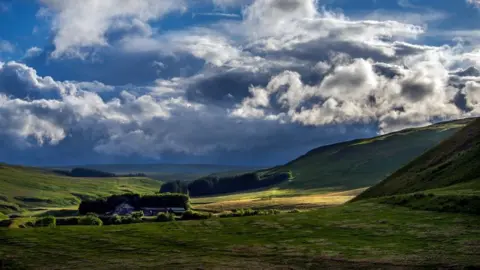 Ian Glendinning A dark and moody image of the Coquet valley, a remote area of England with clouds hanging over 