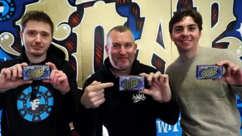 Inkie (centre) with Jack Gascoigne of BillyChip (left) and Zantore Buoy from The Somerset Toiletry Company (right). They are each holding up the soap.