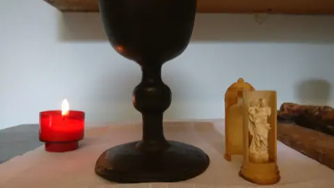Paul Burnell/BBC Artefacts belonging to Edmund Arrowsmith - a chalice and tiny statue of he Virgin Mary .