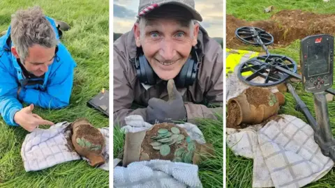 Minelab Detectorists lying on grass with Roman coins found in a roman jar in Wales