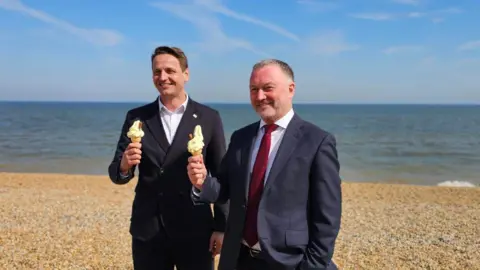 Michael Keohan/ BBC MP for Dover and Deal, Mike Tapp and Environment Steve Reed eat ice creams on the beach at Deal. 