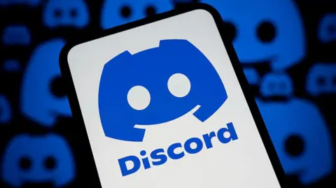 The blue Discord logo on a phone against a white background. In the background are more Discord logos on a black background.