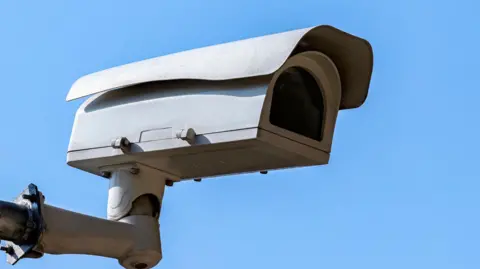 Getty Images A CCTV camera against a blue sky.