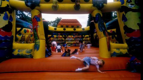 Stock BBC photo of children on a bouncy castle