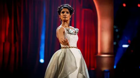 Balvinder Sopal on the Strictly dance floor. she is wearing a cream and grey ball gown. 