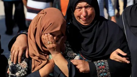 Mourners react following deaths of Palestinians in Israeli fire near a distribution site in Rafah. 