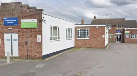 General view of the outside of Whittlesey Community and Youth Centre, a single story building with two cars in the car park.
