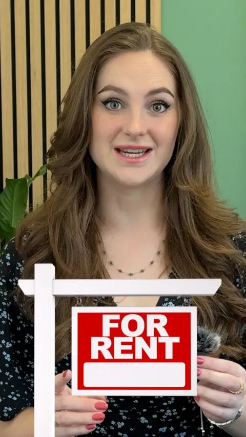 Woman with graphic of 'For rent' sign in front