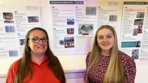 Mother and Daughter Lauren and Louise Jenkins at the group's 100 year exhibition, with Lauren's grandmother pictured behind.