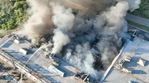 Smoke rises from a shopping centre in the central Ukrainian city of Kryvyi Rih after a Russian drone attack. Photo: 21 August 2026