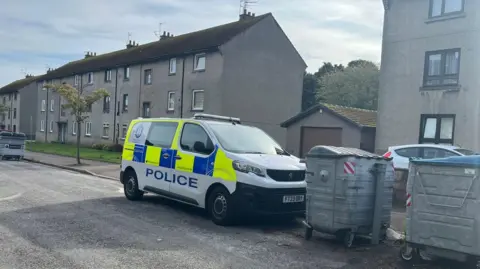 BBC A police van in Cadenhead Place, Aberdeen